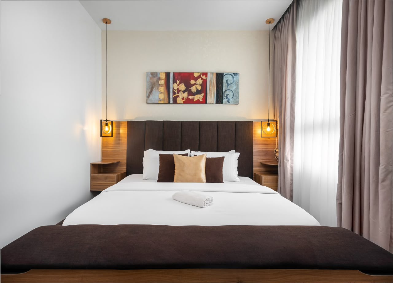 Eko Pearl Tower 11th-floor apartment bedroom with warm bedside lighting