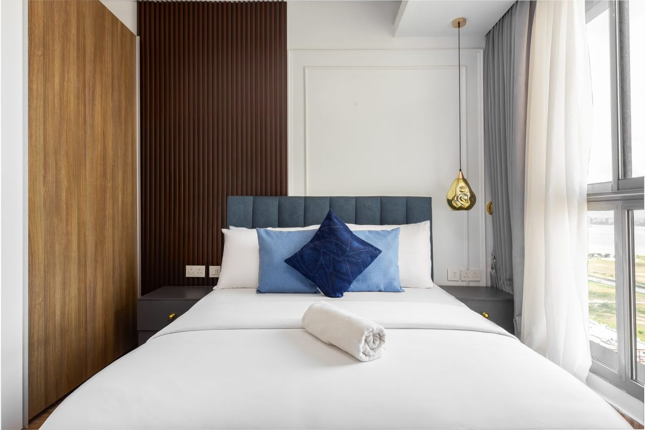 Eko Pearl bedroom with blue pillows and city view