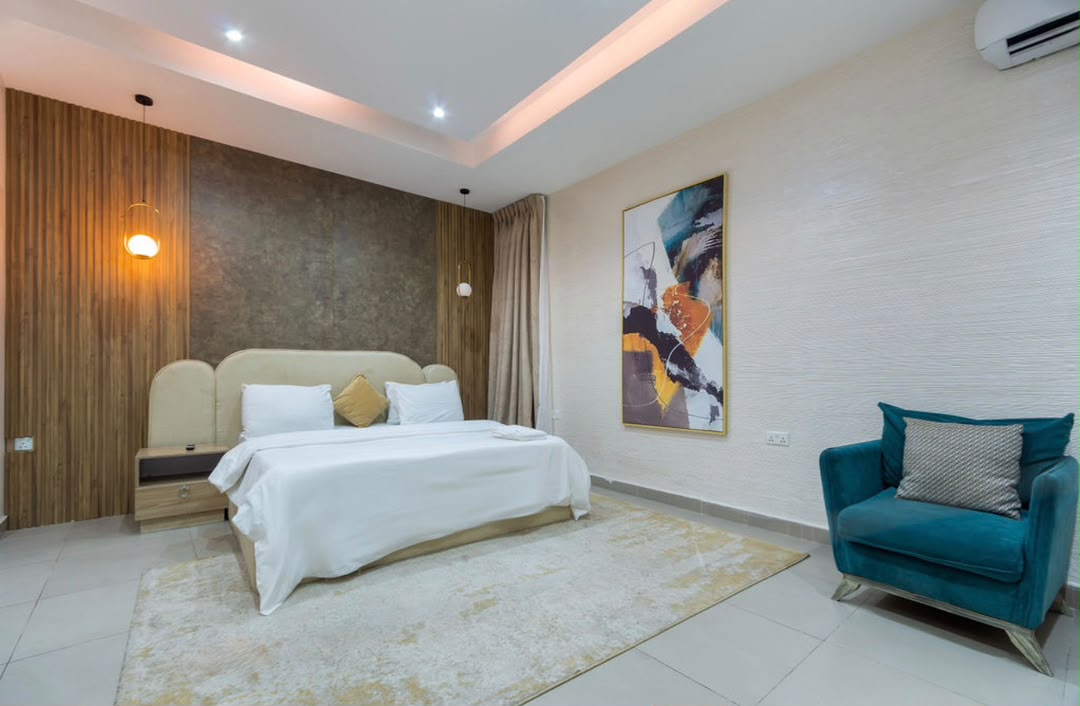Maisonette bedroom with teal accent chair