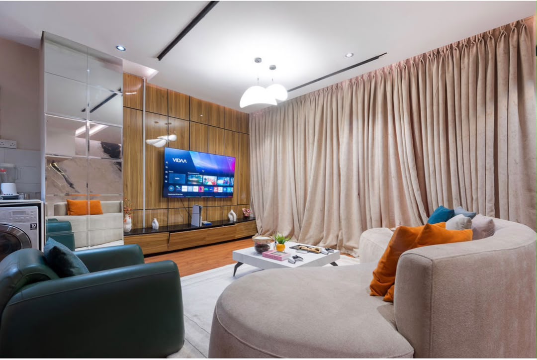 Maisonette lounge with curved sofa and TV wall