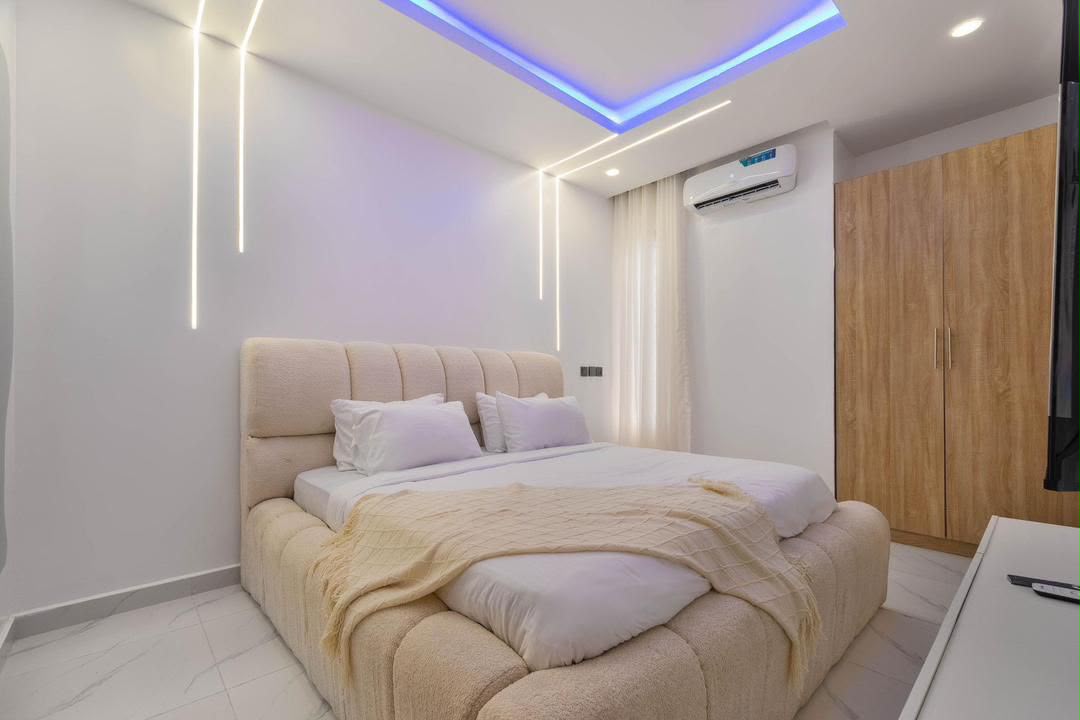 Bedroom with warm lighting in Ikate apartment